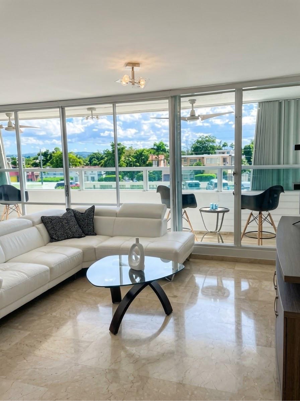 Bright living room with a sectional sofa and ocean-view windows
